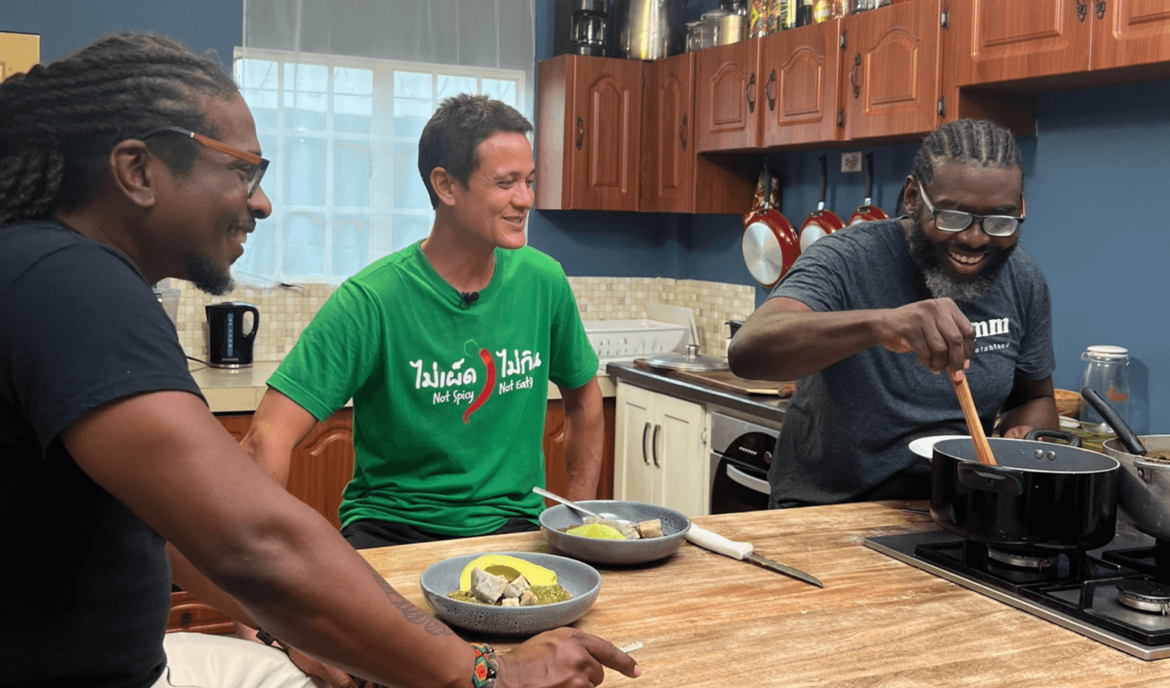 Mark Wiens with Baidawi of Eatahfood and David from D Market Movers, eating Callaloo in Trinidad and Tobago